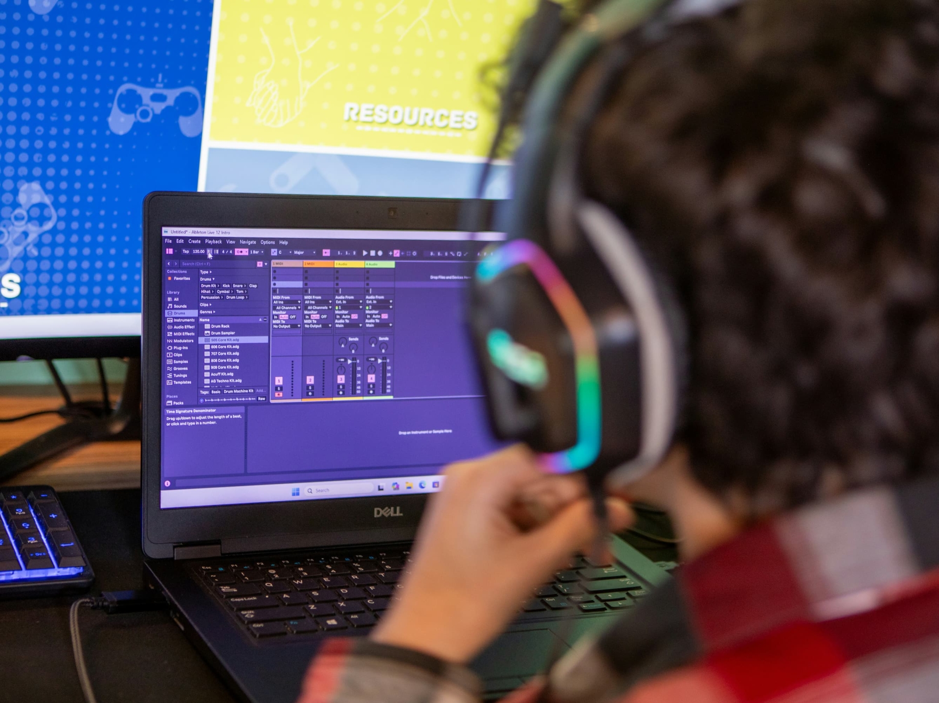 a video engineer with headphones in front of a laptop